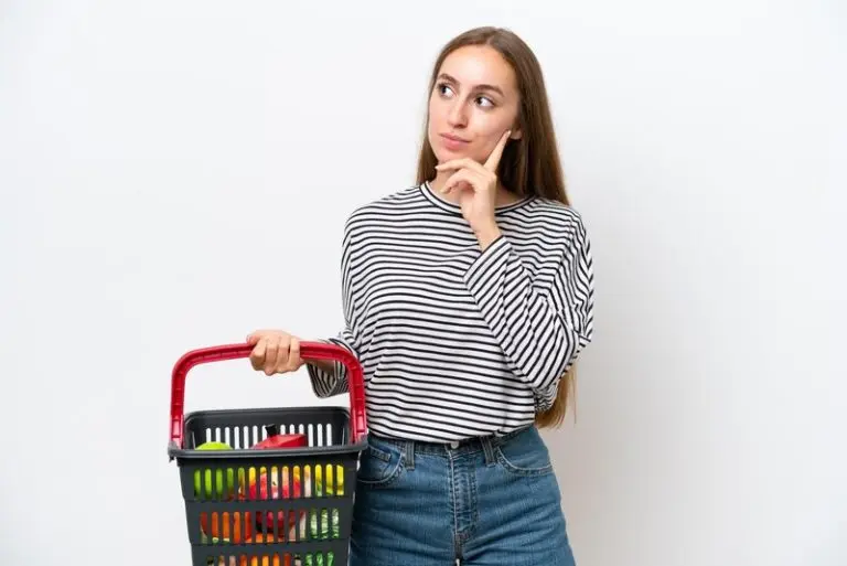 young-rumanian-woman-holding-shopping-basket-full-food-isolated-white-background-thinking-idea-while-looking-up_1368-410592-768x513